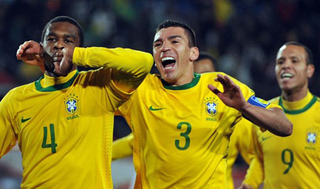 Brazil's defender Juan (L) celebrates after scoring with Brazil's defender Lucio (3) and Brazil's striker Luis Fabiano during the 2010 World Cup round of 16 match Brazil vs Chile on June 28, 2010 at Ellis Park stadium in Johannesburg.